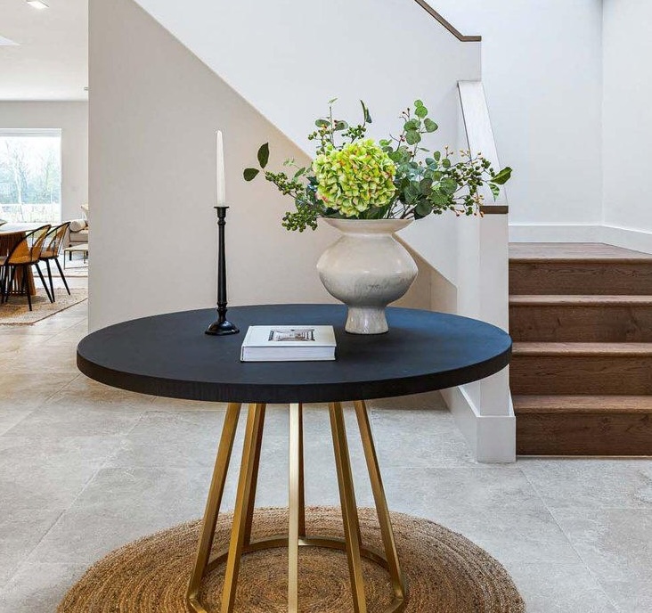 Round dining table with brass base and concrete resin top medium sized seats 4-6