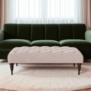 Swoon footstool upholstered in blush house weave and dark oak turned legs