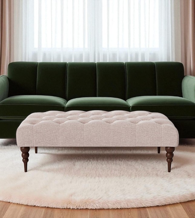 Swoon footstool upholstered in blush house weave and dark oak turned legs