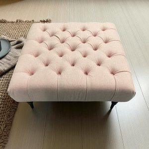 pink button-tufted upholstery footstool