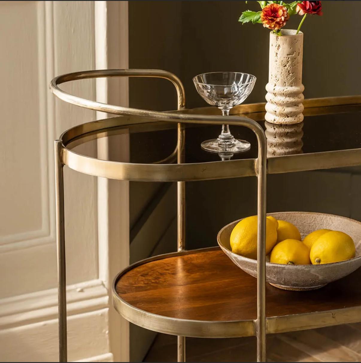 Drinks trolley with three shelves. Moves on discreet castors.