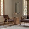 A pair of brown leather armchairs